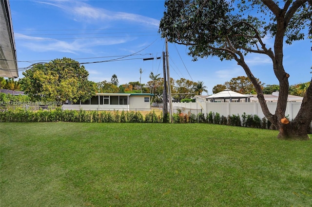 view of yard featuring a sunroom and fence