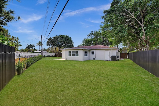 view of yard featuring a fenced backyard and central air condition unit