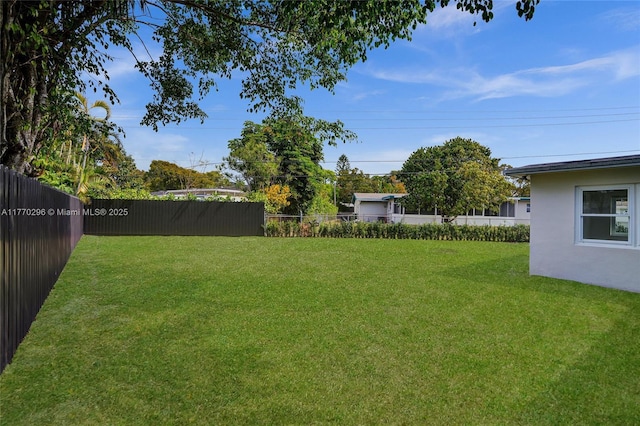 view of yard with a fenced backyard