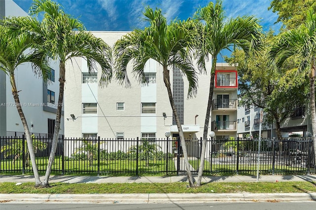 view of building exterior with fence