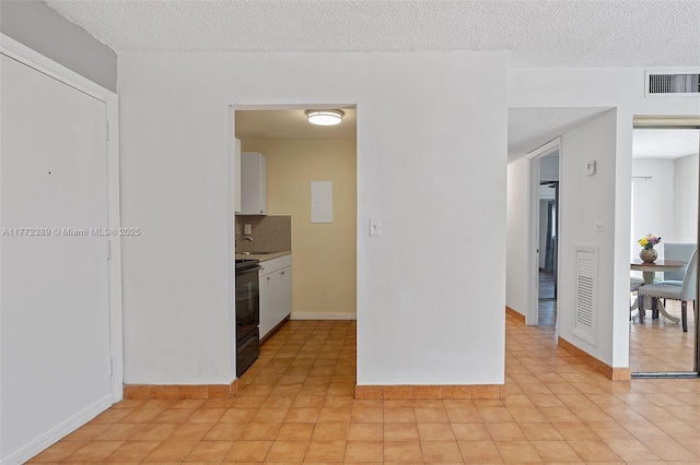 kitchen with tasteful backsplash, a textured ceiling, black electric range, white cabinets, and visible vents