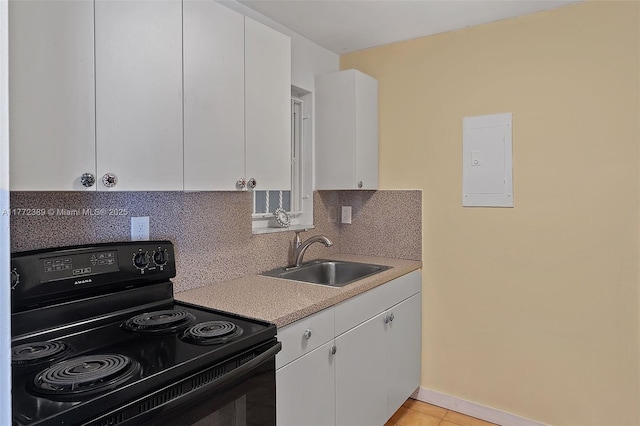 kitchen featuring black electric range, tasteful backsplash, white cabinetry, and a sink