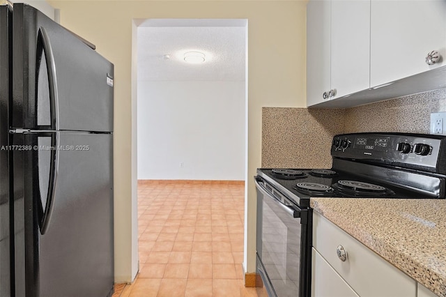 kitchen with a textured ceiling, white cabinets, light stone countertops, decorative backsplash, and black appliances