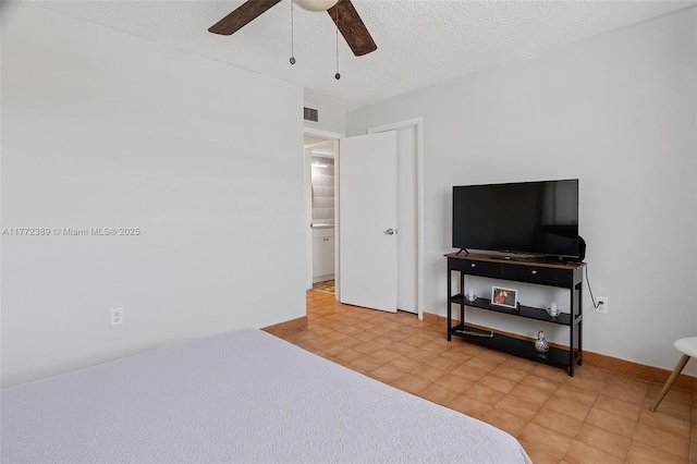 bedroom featuring visible vents, ceiling fan, baseboards, and a textured ceiling