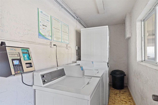 community laundry room featuring washing machine and clothes dryer and light floors
