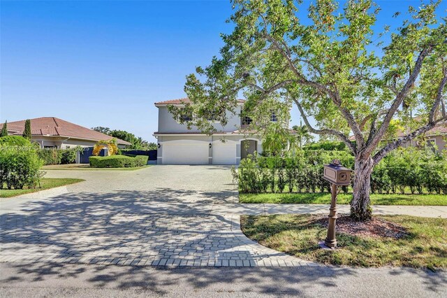 721 Ranch Rd, Weston, FL 33326 - view of front of house with decorative driveway, a garage, and stucco siding