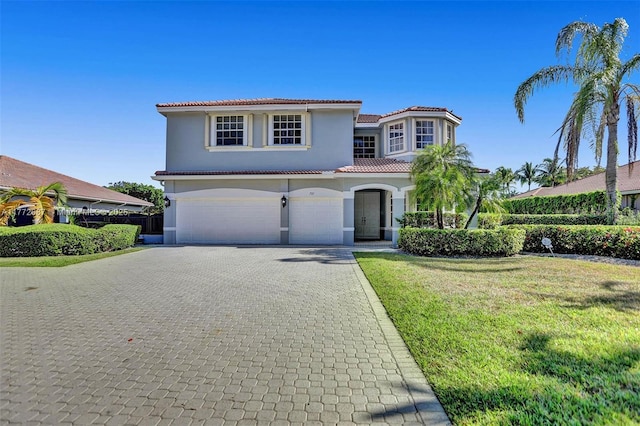 721 Ranch Rd, Weston, FL 33326 - mediterranean / spanish home featuring a tiled roof, decorative driveway, a garage, stucco siding, and a front lawn