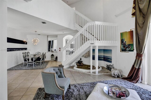 721 Ranch Rd, Weston, FL 33326 - tiled living room featuring a chandelier, stairway, and a high ceiling