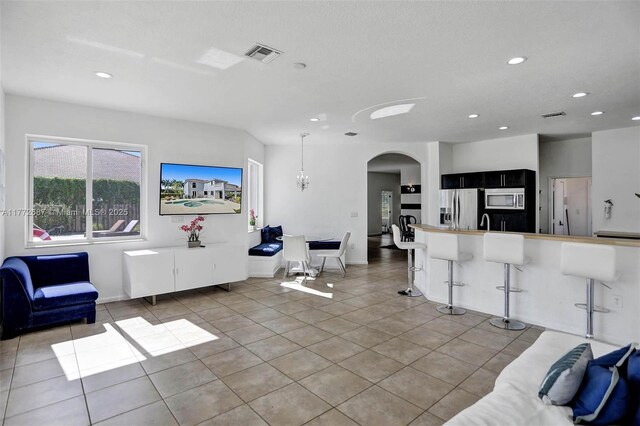 721 Ranch Rd, Weston, FL 33326 - living area with arched walkways, recessed lighting, and light tile patterned floors