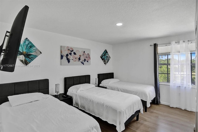 721 Ranch Rd, Weston, FL 33326 - bedroom featuring a textured ceiling, wood finished floors, and recessed lighting