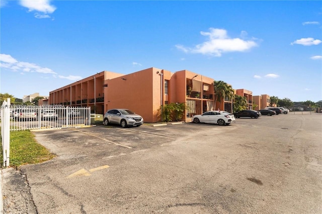1300 W 47th Pl Unit 217B, Hialeah, FL 33012 - uncovered parking lot featuring fence