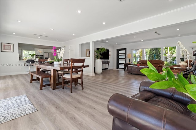 dining area with light wood-style flooring, a wealth of natural light, and recessed lighting