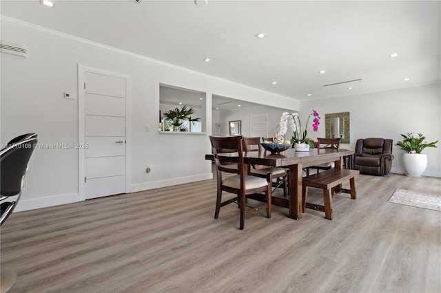dining space with light wood finished floors, baseboards, and recessed lighting