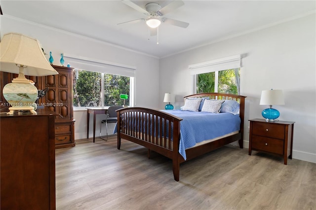 bedroom featuring crown molding, light wood finished floors, baseboards, and multiple windows