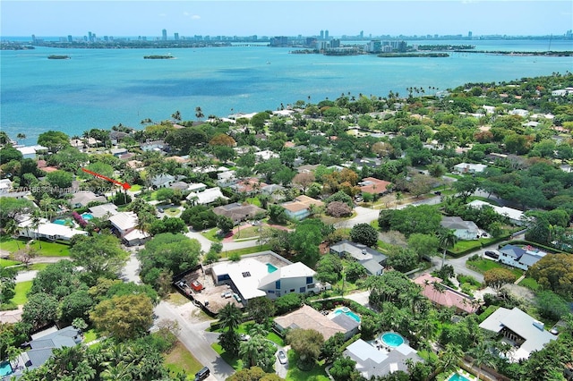 drone / aerial view featuring a water view and a view of city
