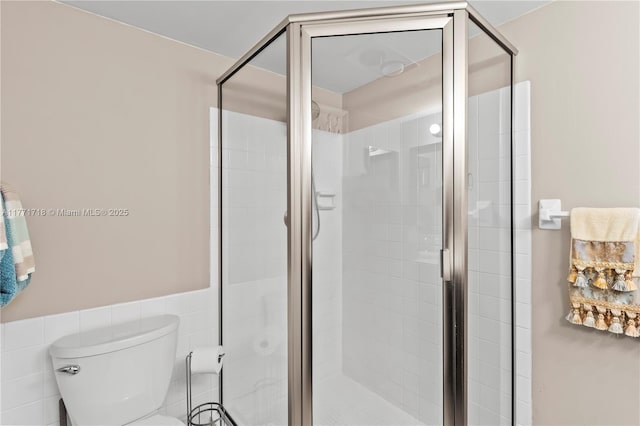 4800 Bayview Dr Unit 402, Fort Lauderdale, FL 33308 - full bathroom with a shower stall, toilet, tile walls, and a wainscoted wall