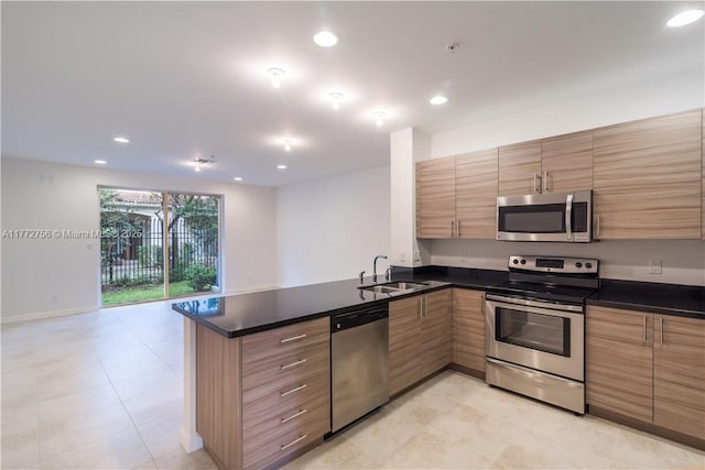 2664 SW 81st Ter Unit 2666, Miramar, FL 33025 - kitchen with appliances with stainless steel finishes, a peninsula, dark countertops, recessed lighting, and light tile patterned floors