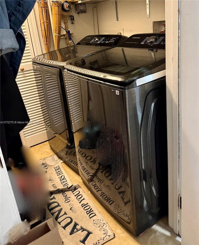 washroom featuring laundry area and separate washer and dryer