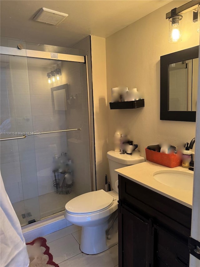 bathroom featuring a shower stall, vanity, visible vents, and toilet