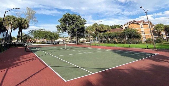 view of sport court featuring fence
