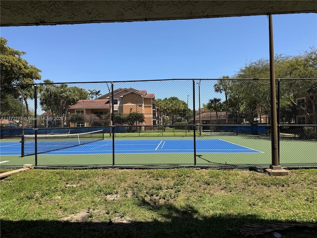 view of tennis court with fence