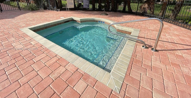 view of pool with a patio area and fence