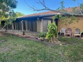 11041 SW 166th Ter, Miami, FL 33157 - rear view of house with a yard