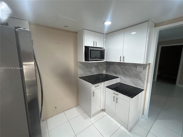 5701 Collins Ave Unit 812, Miami Beach, FL 33140 - kitchen featuring appliances with stainless steel finishes, light tile patterned flooring, tasteful backsplash, white cabinets, and recessed lighting