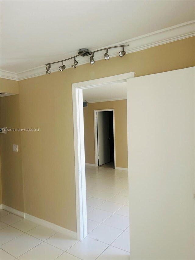 5701 Collins Ave Unit 812, Miami Beach, FL 33140 - spare room with crown molding and light tile patterned floors