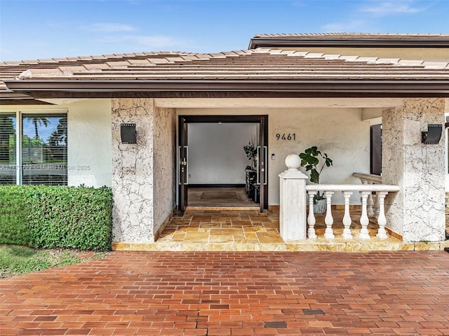 9461 SW 128th St, Miami, FL 33176 - doorway to property with stucco siding and a tiled roof