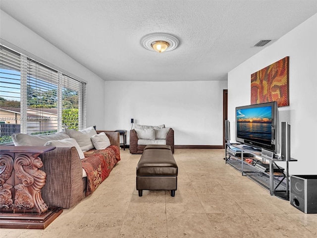 9461 SW 128th St, Miami, FL 33176 - living area with a textured ceiling, baseboards, and visible vents
