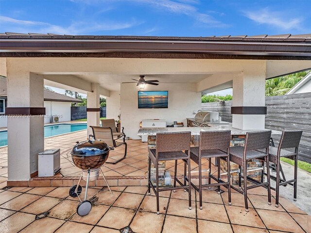 9461 SW 128th St, Miami, FL 33176 - view of patio with an outdoor pool, outdoor wet bar, a grill, a ceiling fan, and area for grilling