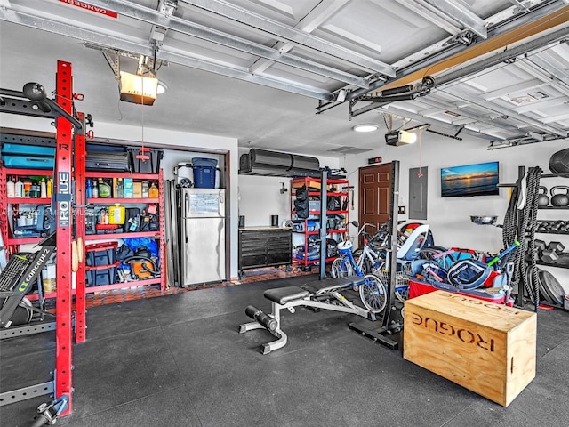 9461 SW 128th St, Miami, FL 33176 - garage with freestanding refrigerator, a garage door opener, and electric panel
