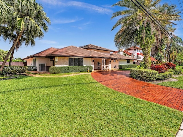 9461 SW 128th St, Miami, FL 33176 - view of front facade with a tiled roof, a front yard, and stucco siding