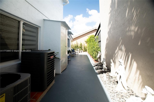 exterior space featuring stucco siding and central AC