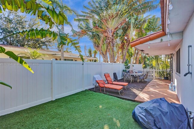 1441 NW 10, Dania Beach, FL 33004 - view of yard featuring a fenced backyard, a wooden deck, and outdoor dining space