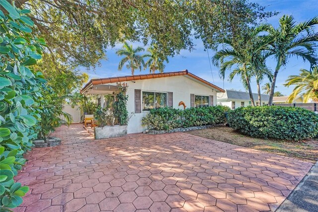 1441 NW 10, Dania Beach, FL 33004 - exterior space featuring stucco siding and a patio area