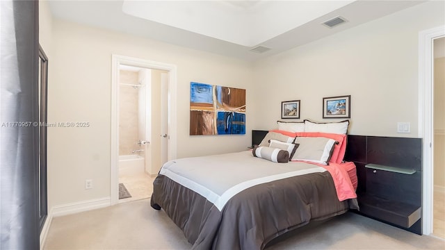 bedroom featuring ensuite bath, visible vents, and baseboards