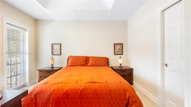 bedroom featuring baseboards, light colored carpet, and access to outside