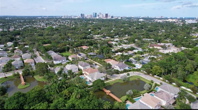 birds eye view of property featuring a water view and a view of city
