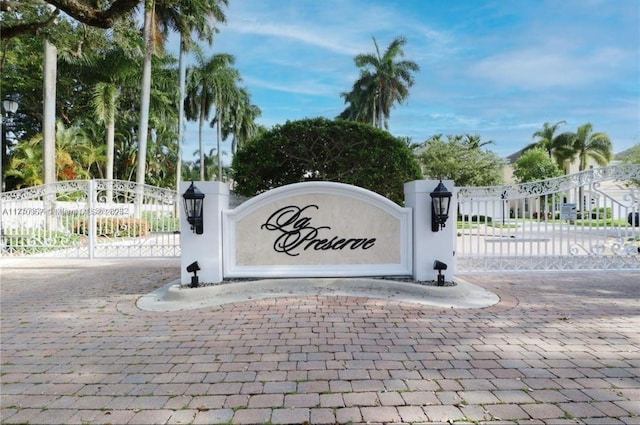 community / neighborhood sign with a gate