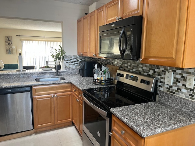 9491 N Palm Cir N Unit 9491, Pembroke Pines, FL 33025 - kitchen featuring appliances with stainless steel finishes, a sink, brown cabinetry, light tile patterned floors, and backsplash