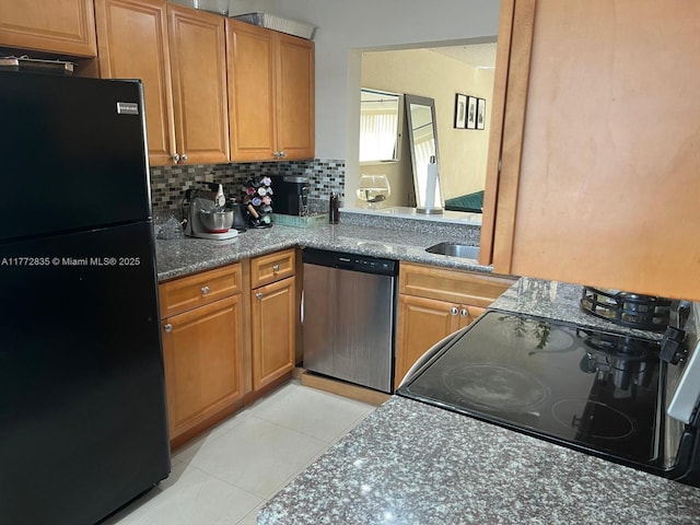 9491 N Palm Cir N Unit 9491, Pembroke Pines, FL 33025 - kitchen featuring light tile patterned floors, tasteful backsplash, brown cabinetry, and black appliances