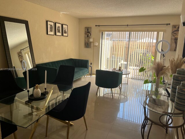 9491 N Palm Cir N Unit 9491, Pembroke Pines, FL 33025 - tiled dining area featuring a textured ceiling and a wealth of natural light