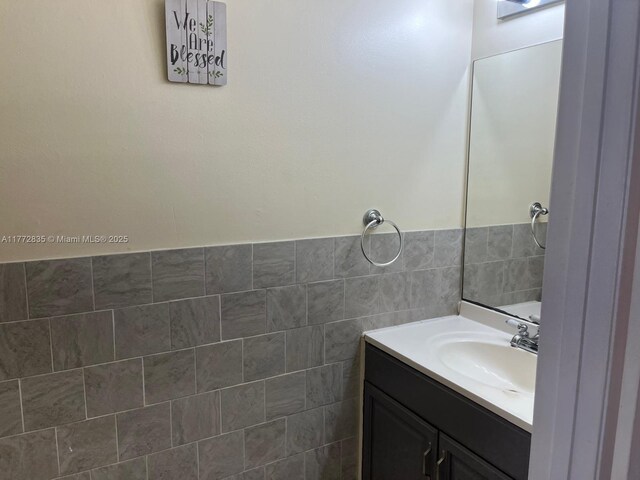 9491 N Palm Cir N Unit 9491, Pembroke Pines, FL 33025 - bathroom featuring vanity and tile walls