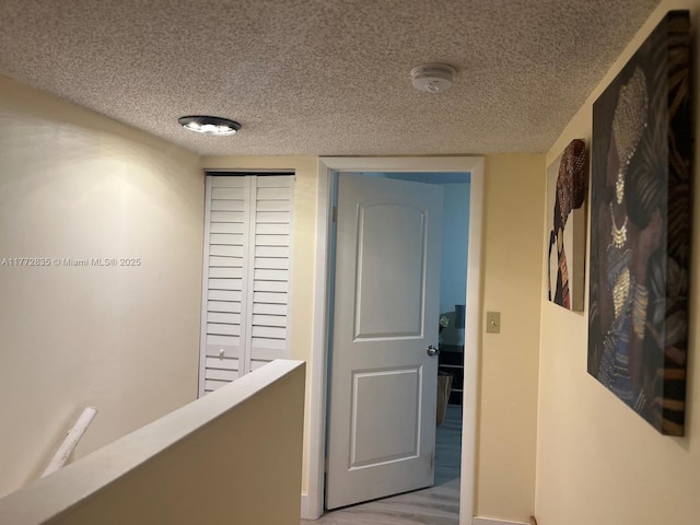 9491 N Palm Cir N Unit 9491, Pembroke Pines, FL 33025 - corridor with baseboards, a textured ceiling, and wood finished floors