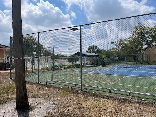 9491 N Palm Cir N Unit 9491, Pembroke Pines, FL 33025 - view of tennis court featuring fence