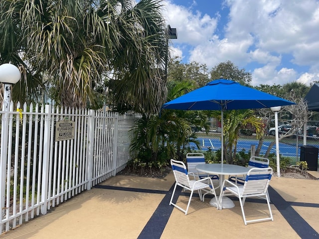 9491 N Palm Cir N Unit 9491, Pembroke Pines, FL 33025 - view of patio / terrace featuring fence and outdoor dining space