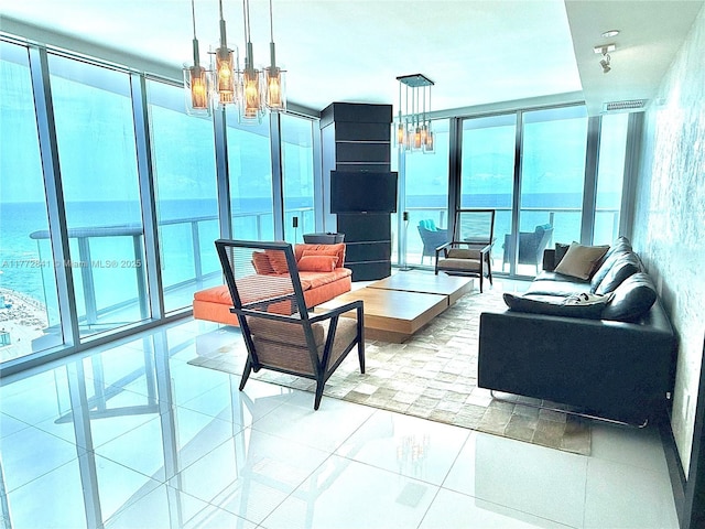 17001 Collins Ave Unit 2508, Sunny Isles Beach, FL 33160 - living area featuring a chandelier, expansive windows, tile patterned flooring, and a water view