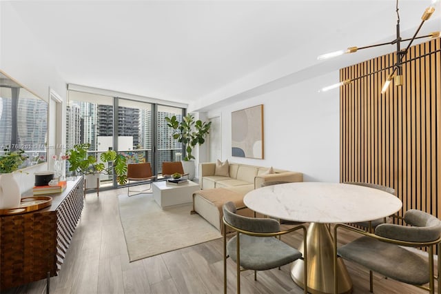 dining area featuring floor to ceiling windows and wood finished floors